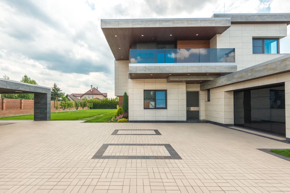 Decorative concrete driveway and entry hardscape at a modern home.